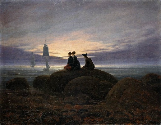 romantic sunset near dark from beach 2 women one man seated foreground